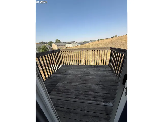 a view of a balcony with a table and chairs