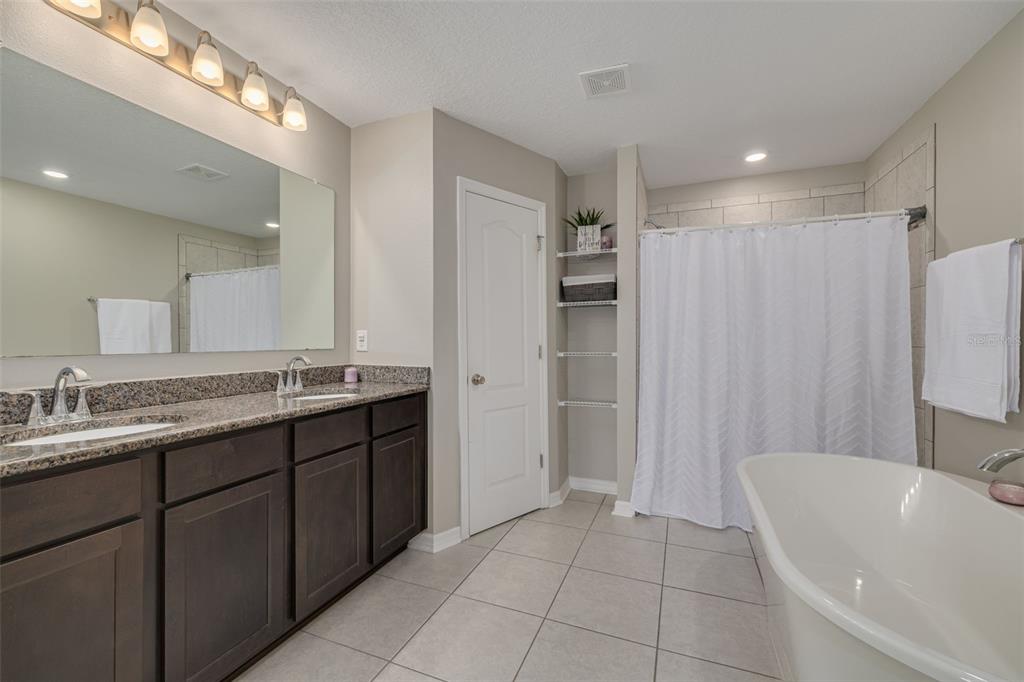 7242 Landmark Drive Spring Hill, FL 34606 - Photo 31 of 45 a bathroom with a double vanity sink and a mirror