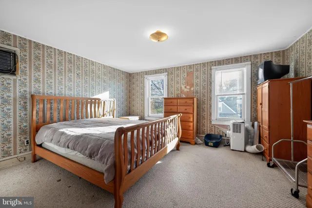 a bed sitting in a room next to a window