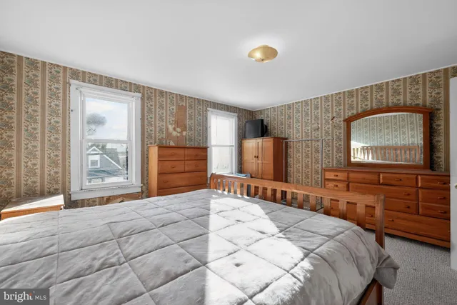 a bedroom with a large bed and a dresser