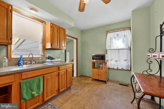 a kitchen with stainless steel appliances granite countertop a sink and a refrigerator