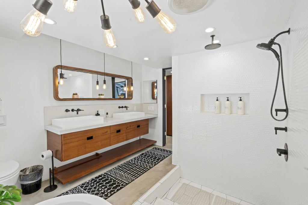 754 El Rancho Drive El Cajon, CA 92019 - Photo 21 of 55 a bathroom with a sink a mirror and a shower