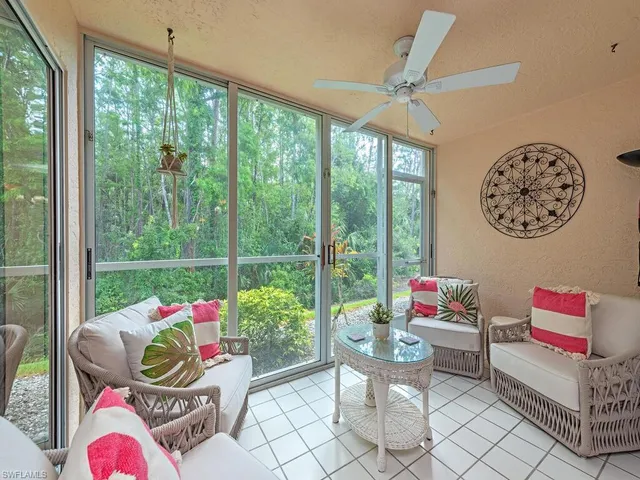 a living room filled with furniture and a floor to ceiling window