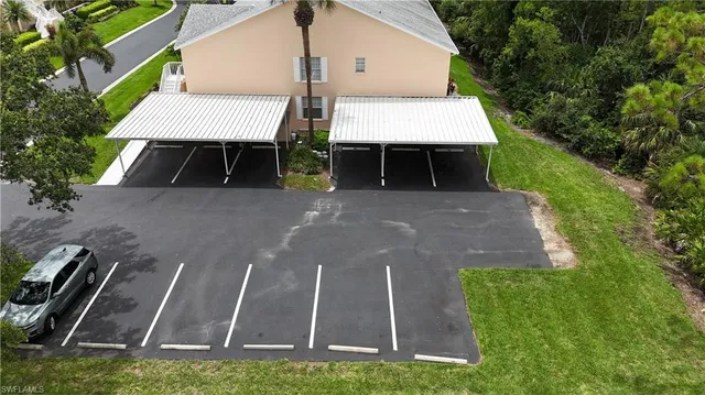 a view of a patio with table and chairs with wooden floor and fence