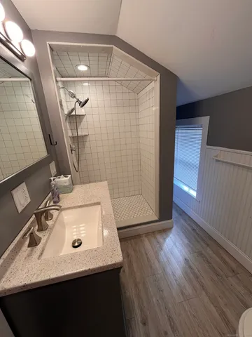 a bathroom with a sink a mirror and shower
