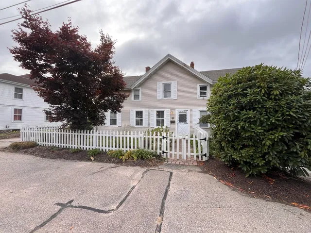 a view of a house with wooden fence