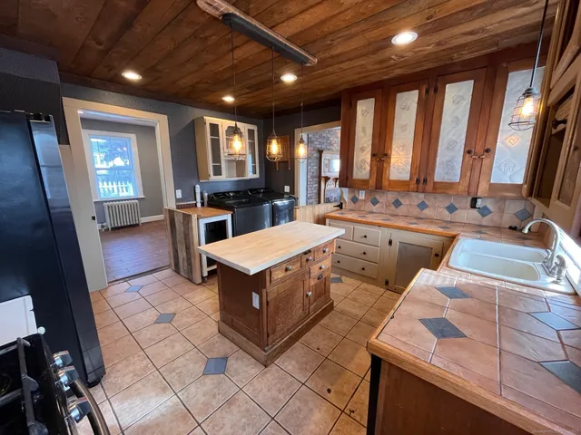 a large white kitchen with a large window
