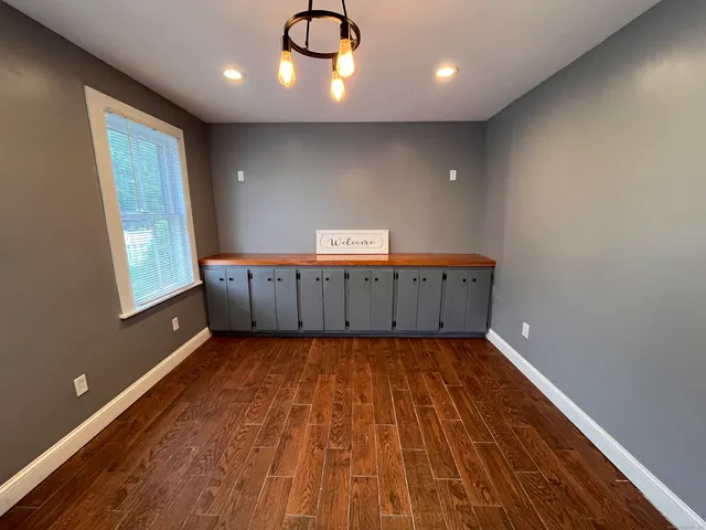 a view of a livingroom with a hall and wooden floor