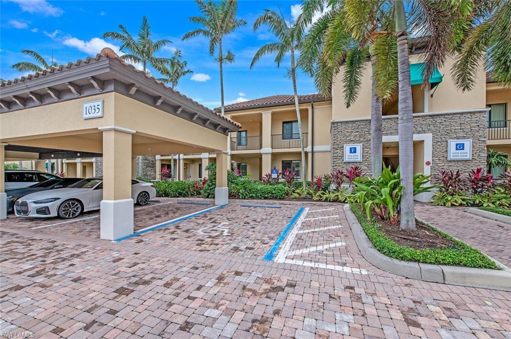 1035 Sandpiper Street, Unit F104 Naples, FL 34102 - Photo 18 of 24 a view of a car park in front of a building