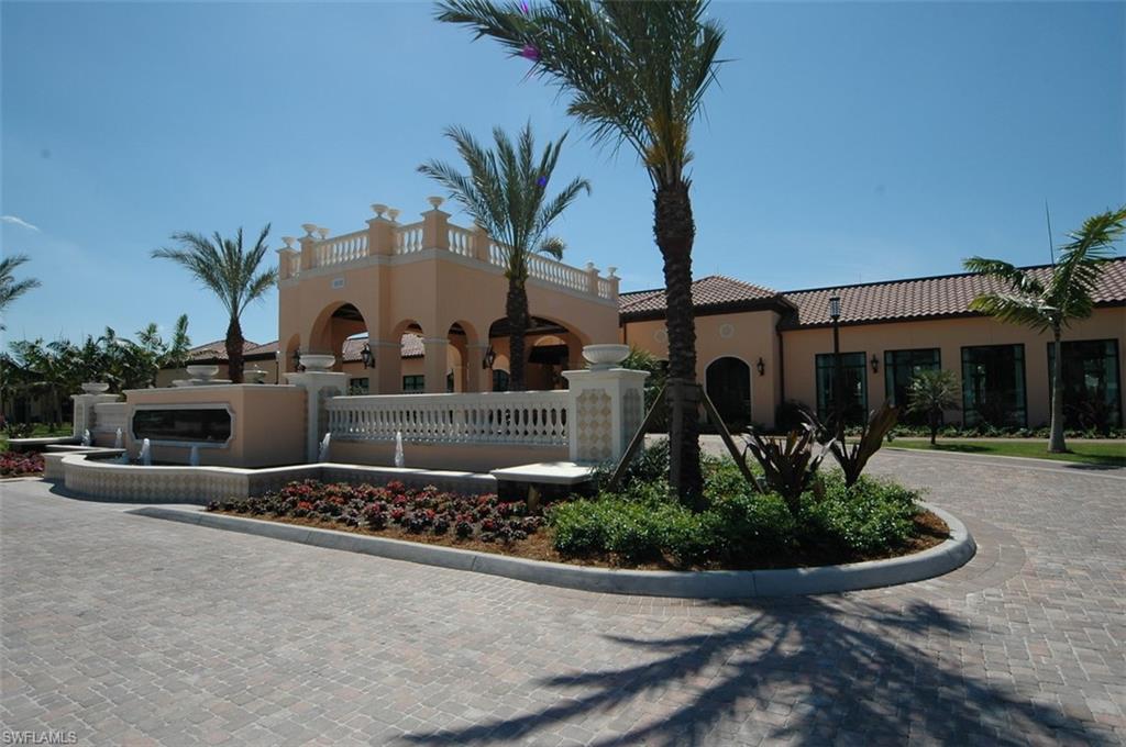 1035 Sandpiper Street, Unit F104 Naples, FL 34102 - Photo 19 of 24 a front view of a house with yard and parking