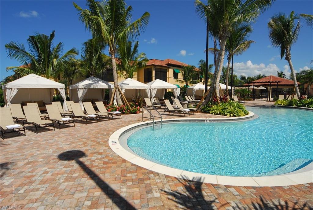 1035 Sandpiper Street, Unit F104 Naples, FL 34102 - Photo 21 of 24 a swimming pool with outdoor seating yard and barbeque oven
