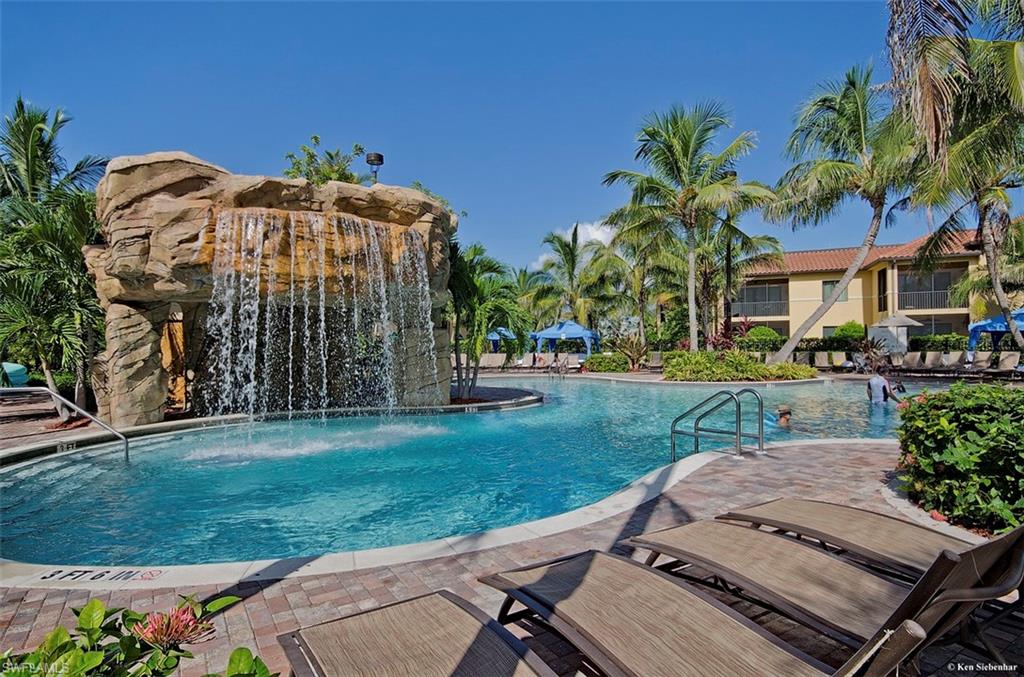 1035 Sandpiper Street, Unit F104 Naples, FL 34102 - Photo 23 of 24 a view of a front of house with a yard