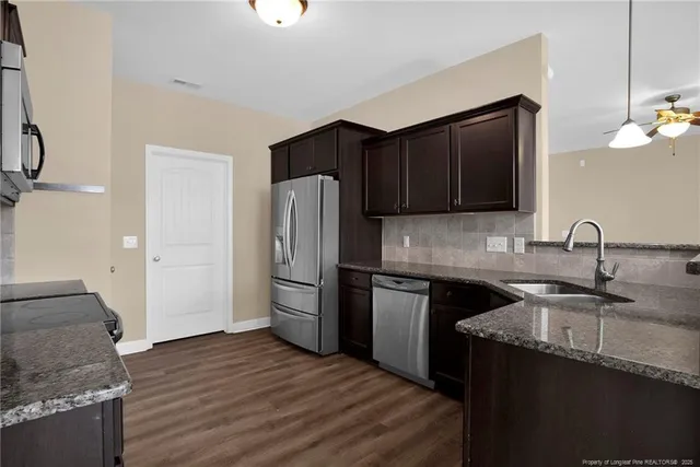 a kitchen with a sink and a refrigerator