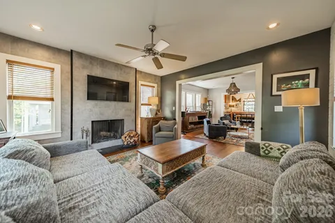 a living room with furniture fireplace and flat screen tv