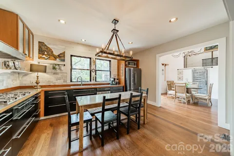 a dining room with furniture window and wooden floor