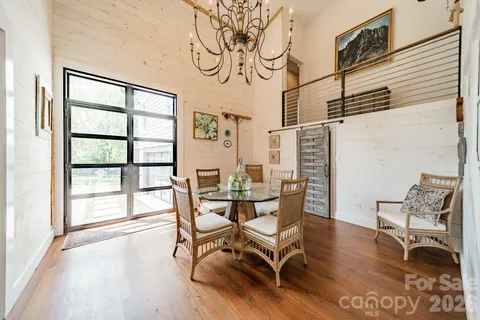 a dining room with furniture and wooden floor