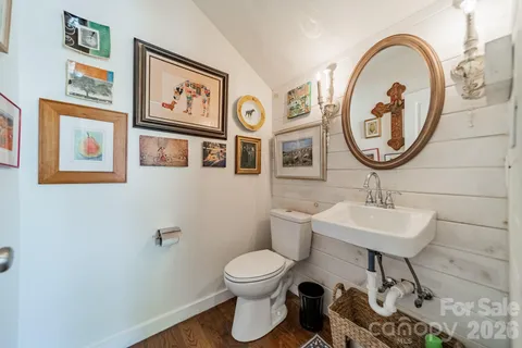 a bathroom with a toilet a sink and a mirror