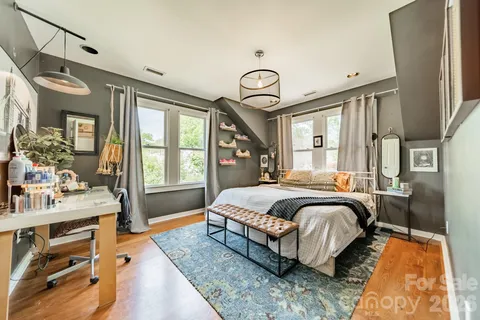 a spacious bedroom with a bed and window