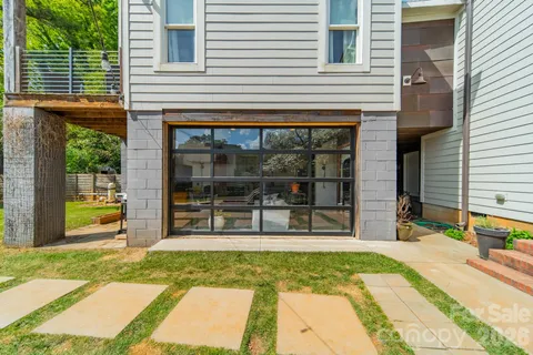 a view of a house with a backyard and a balcony