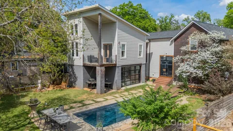 an aerial view of a house with yard swimming pool and outdoor seating