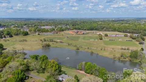 an aerial view of residential houses with outdoor space and river