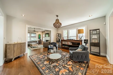 a living room with furniture and a chandelier
