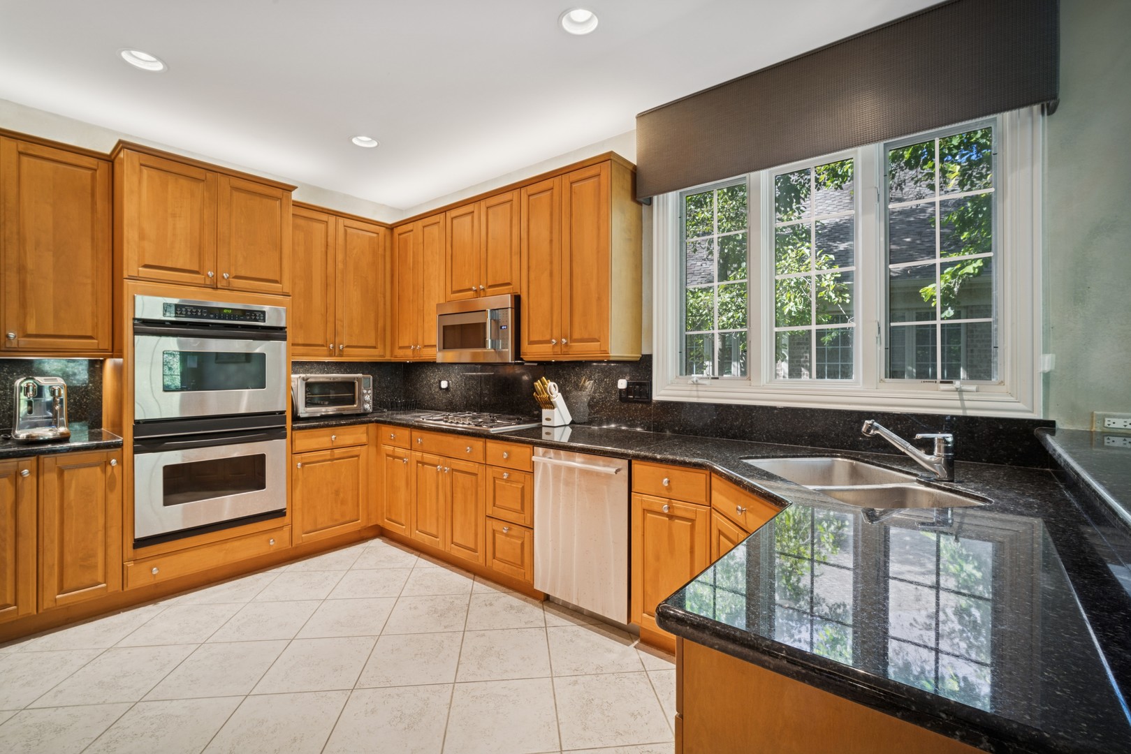 857 Country Club Lane Northbrook, IL 60062 - Photo 5 of 27 a kitchen with stainless steel appliances granite countertop a stove sink and cabinets