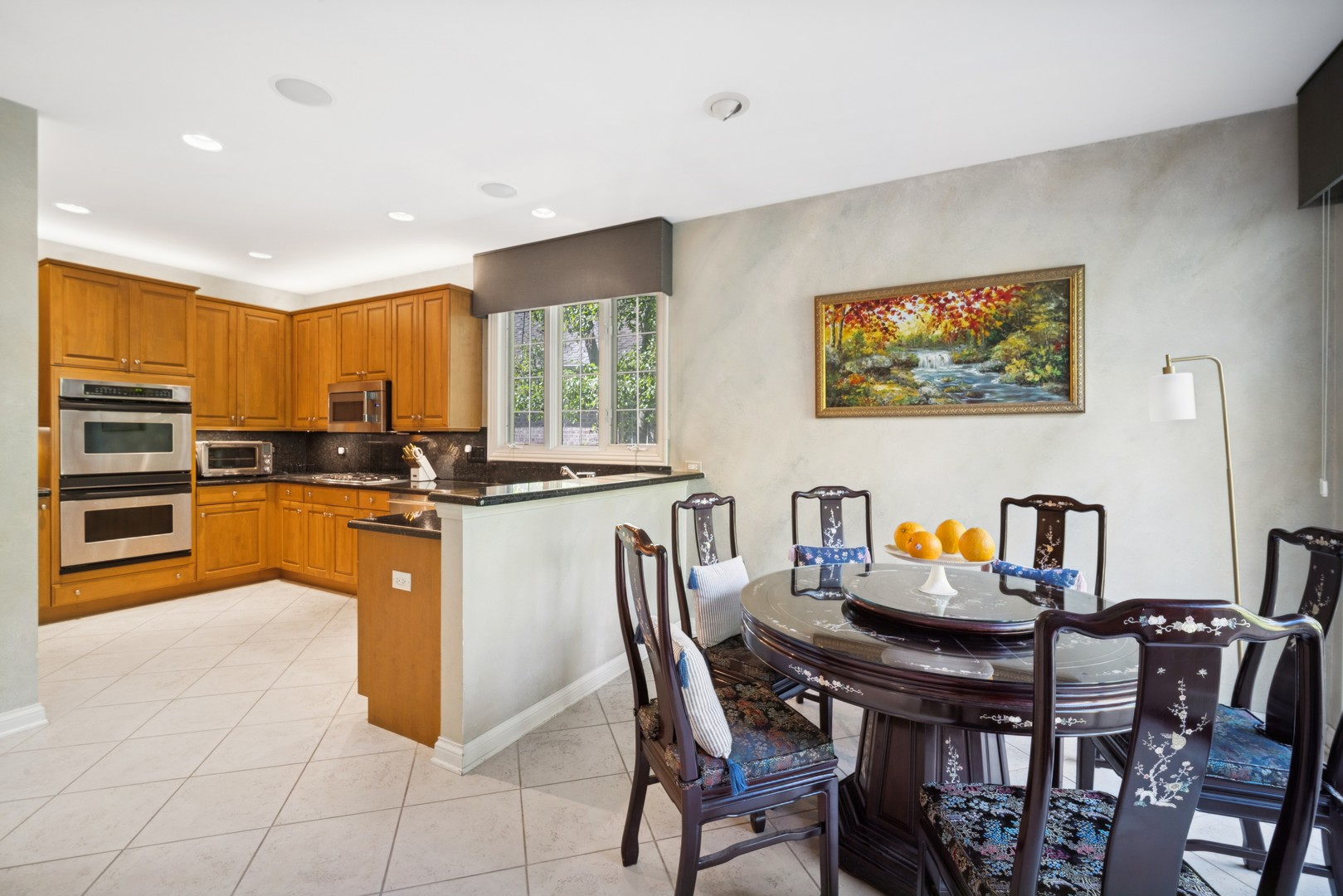 857 Country Club Lane Northbrook, IL 60062 - Photo 6 of 27 a kitchen with stainless steel appliances granite countertop a stove a sink a dining table and chairs