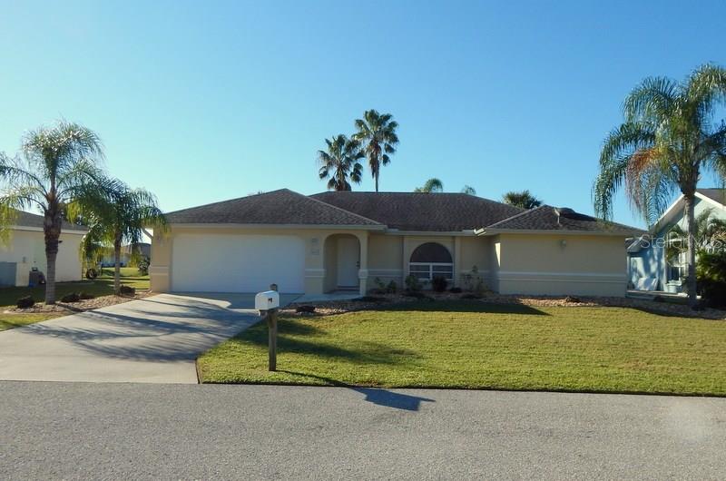 661 Trumpet Tree Punta Gorda, FL 33955 - Photo 1 of 1 a front view of a house with a yard and garage