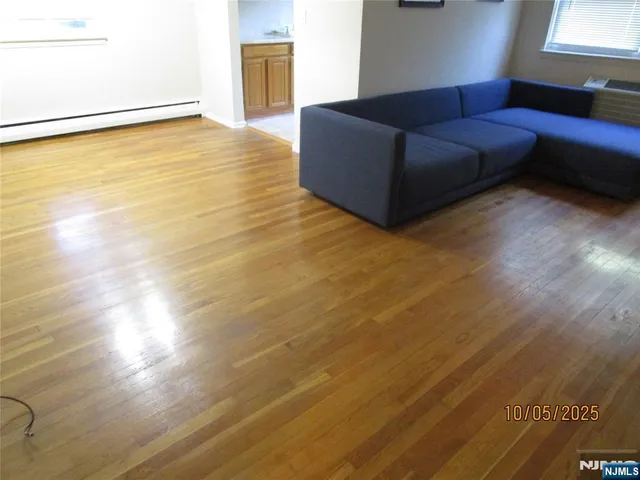 a living room with a couch wooden floor and a table