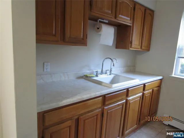 a kitchen with stainless steel appliances granite countertop a sink dishwasher a cabinets and wooden floor