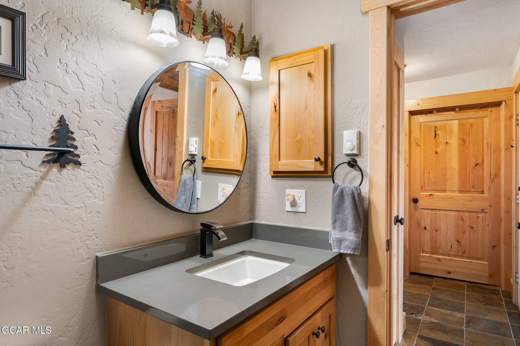 605 Lake Front Road, Unit W8 Grand Lake, CO 80447 - Photo 22 of 28 a bathroom with a sink a vanity and a mirror