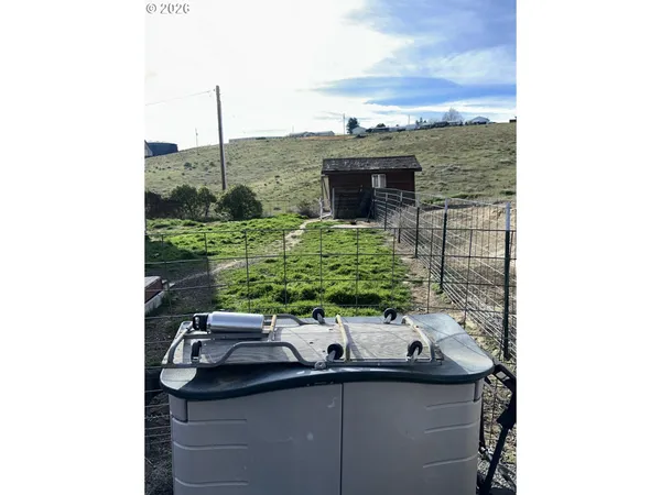 a view of a dry yard with sitting area