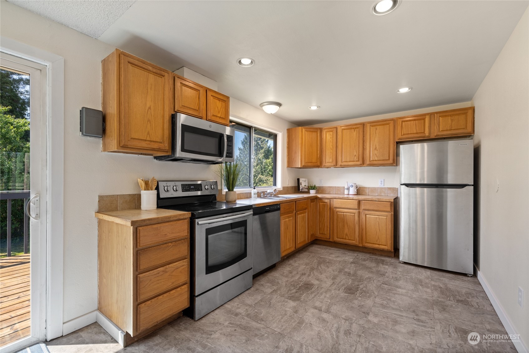3127 South Walden Street Seattle, WA 98144 - Photo 11 of 39 a kitchen with sink cabinets and stainless steel appliances