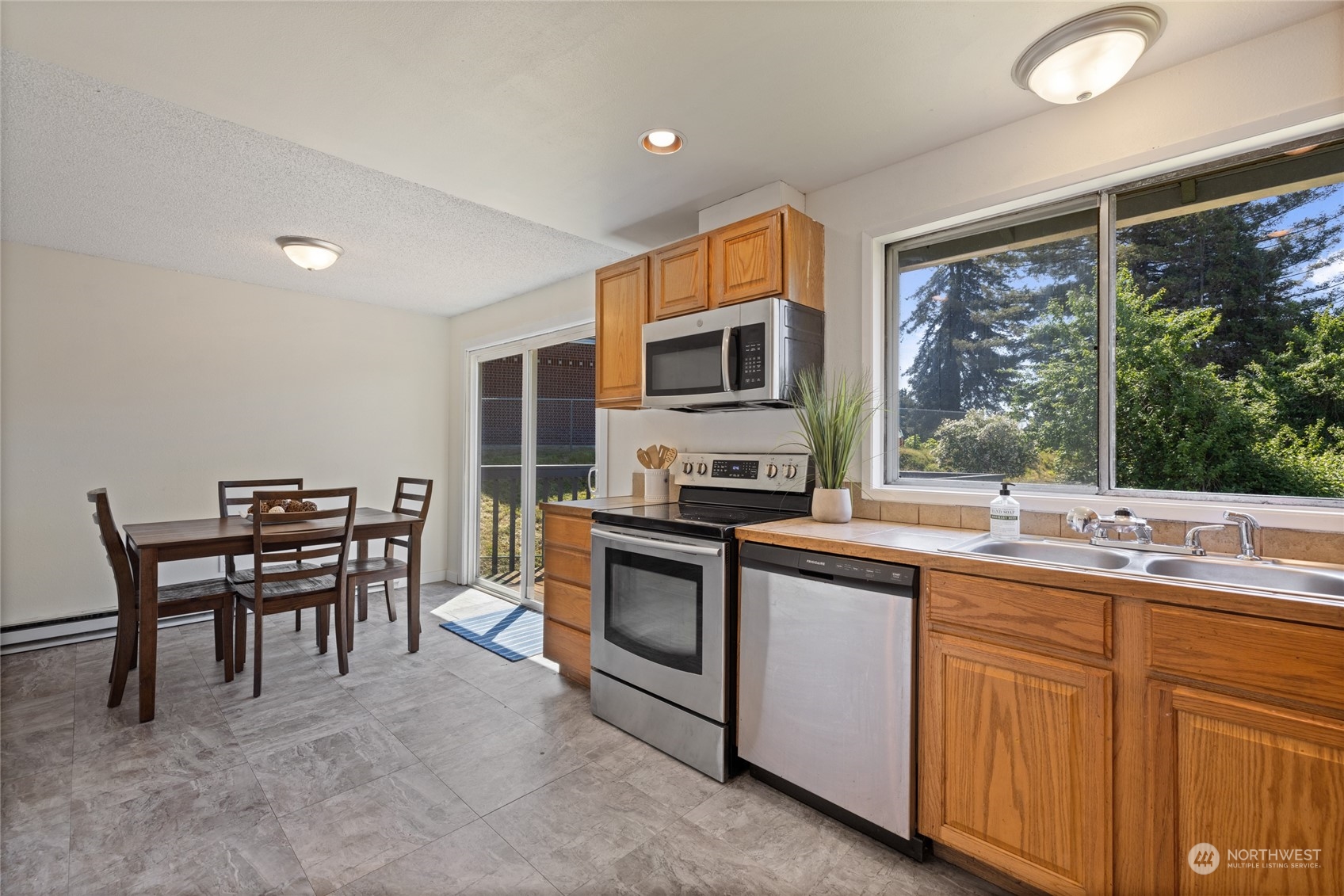 3127 South Walden Street Seattle, WA 98144 - Photo 12 of 39 a kitchen with a sink stove and microwave