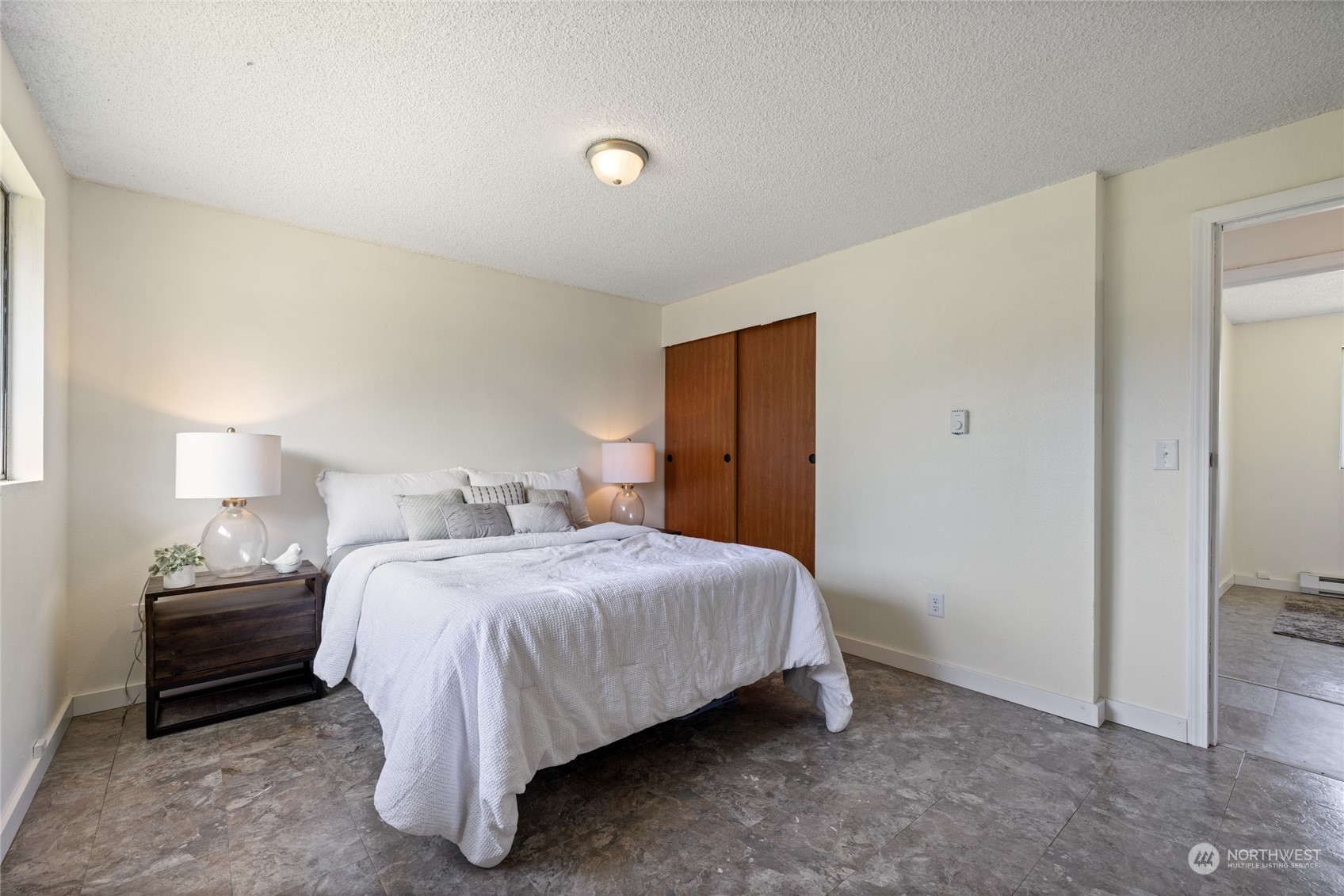 3127 South Walden Street Seattle, WA 98144 - Photo 15 of 39 a bedroom with a bed and a lamp