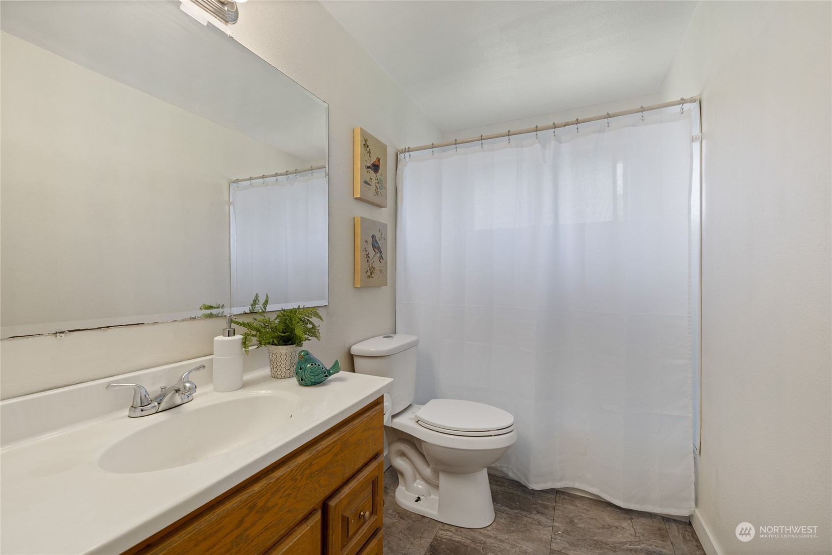 3127 South Walden Street Seattle, WA 98144 - Photo 20 of 39 a bathroom with a sink a toilet and mirror