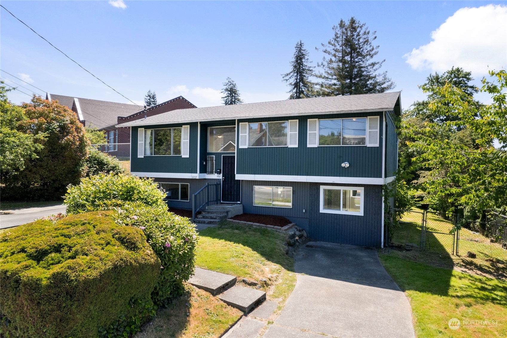 3127 South Walden Street Seattle, WA 98144 - Photo 2 of 39 a front view of a house with a yard