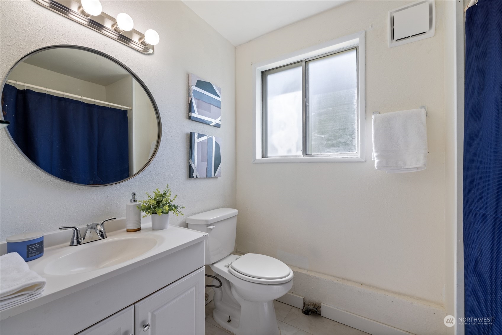 3127 South Walden Street Seattle, WA 98144 - Photo 29 of 39 a bathroom with a toilet a sink and mirror