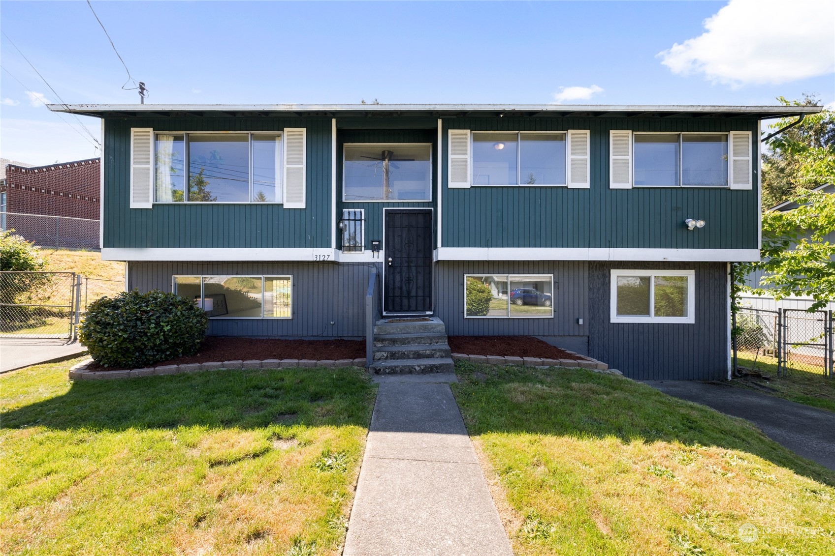 3127 South Walden Street Seattle, WA 98144 - Photo 3 of 39 a front view of a house with garden