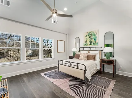 a bedroom with a large bed and a window