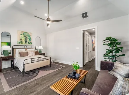 a living room with furniture and a potted plant