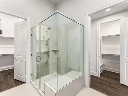 a bathroom with a shower and a glass door