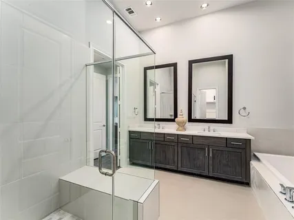 a bathroom with double sink and a mirror