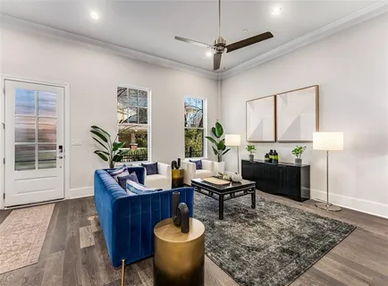 a living room with furniture a couch and a potted plant