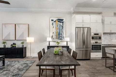 a kitchen with a refrigerator and a stove top oven