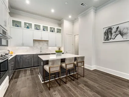 a kitchen with a sink cabinets and wooden floor