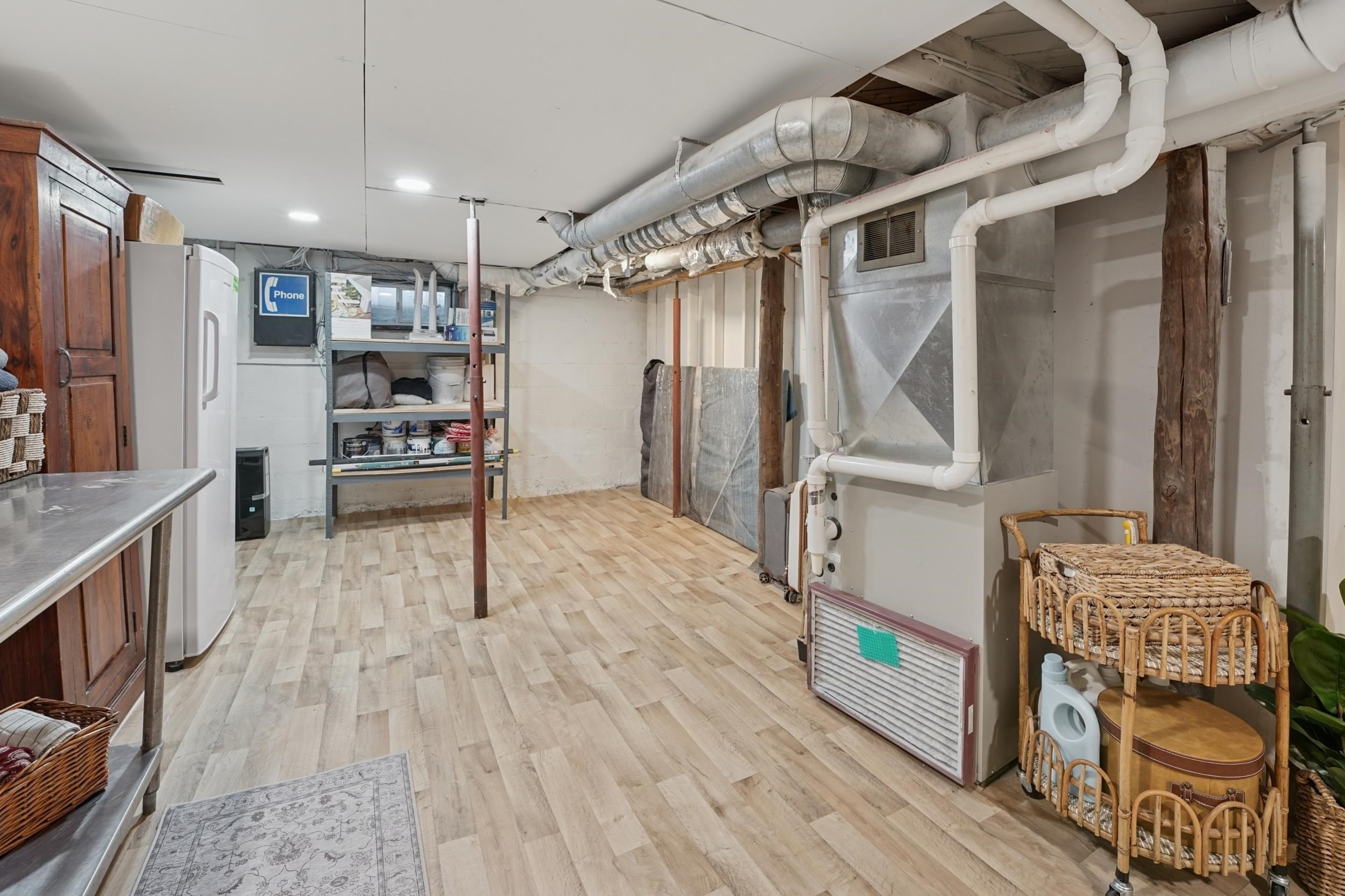 52 Thomson Road Esko, MN 55733 - Photo 14 of 20 Unfinished below grade area with light wood-style floors, freestanding refrigerator, and heating unit