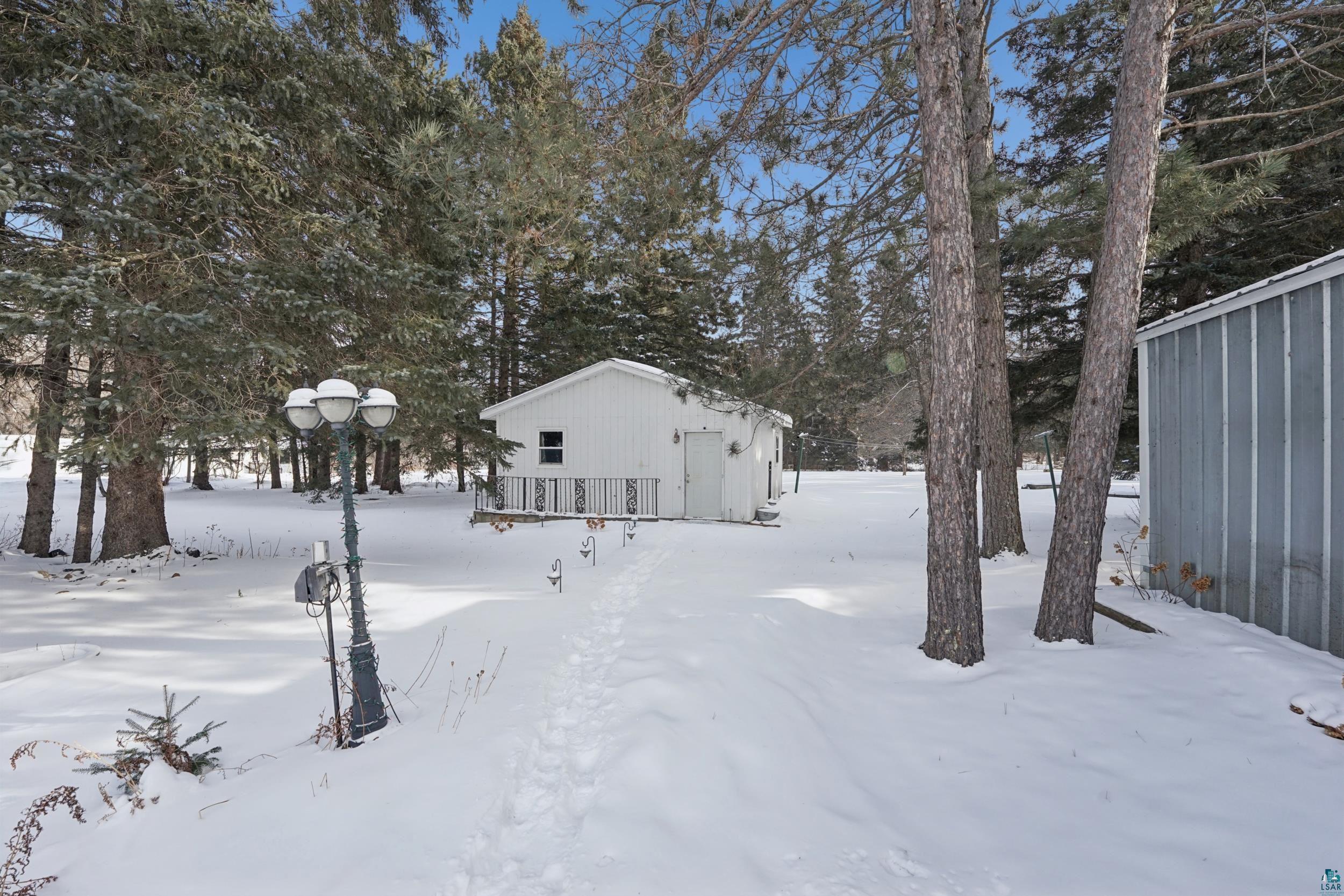 52 Thomson Road Esko, MN 55733 - Photo 17 of 20 Yard layered in snow with view of wooded area