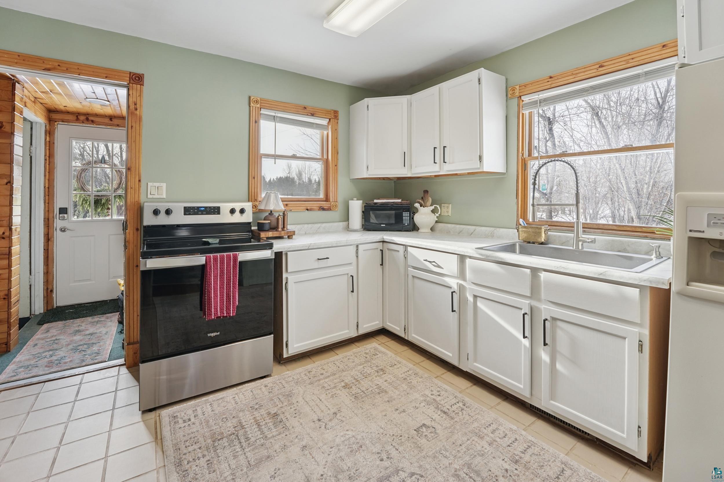 52 Thomson Road Esko, MN 55733 - Photo 3 of 20 Kitchen with stainless steel range with electric cooktop, white cabinets, white refrigerator with ice dispenser, and light countertops